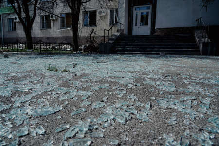 Pieces of broken glass lie on the pavement after the explosion