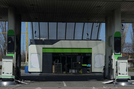 Gas station with a broken station from a shell explosion. Exploded gas station during the war.