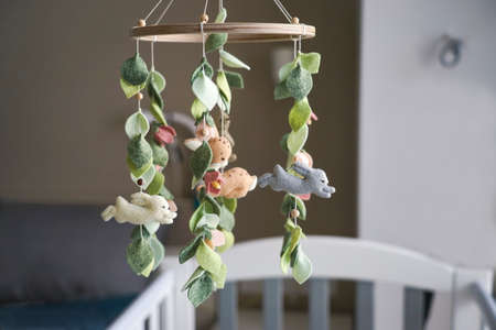 DIY craft baby crib mobile. Toys hang over the cribの写真素材