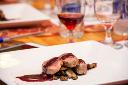 Duck breast with red fruit sauce and mushroom.の写真素材