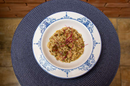 Risotto of vitello with funghi porcini sauce and micro-leaf of beet.の写真素材