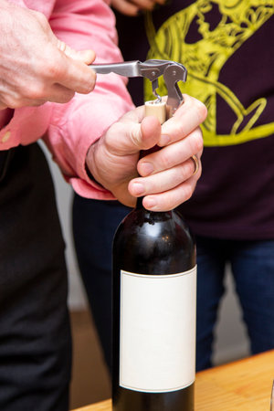 Red wine being opened to be served in tasting.