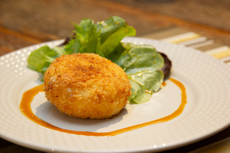 Ballotine de chevre (goat cheese, French) fried with honey sauce.の写真素材