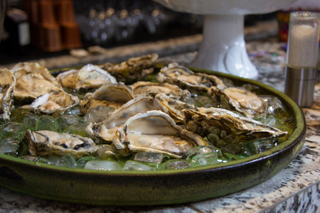 fresh oysters opened under ice board.の写真素材