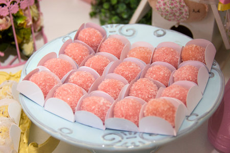 Brigadeiro with strawberry on the decorated birthday table. Traditional Brazilian sweetの写真素材