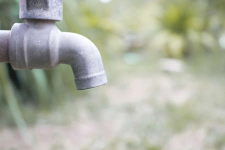 Close up metal blue water faucet Old in the forest. Water shortage concept.