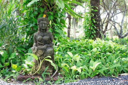 Girl statue, the statue faces smiling young woman, dressed in traditional Thailand.の写真素材