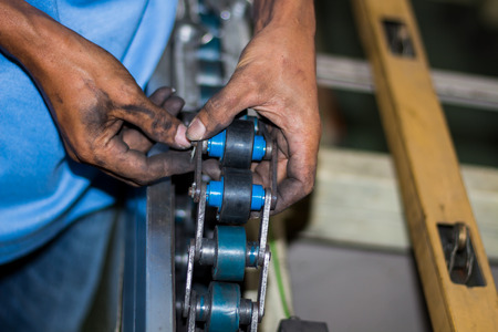 The technician repairing conveyor belt in factoryの写真素材