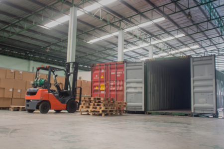 The forklift loading pallet with a forklift into a truck.(Blur picture)の写真素材