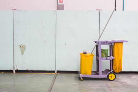 The cleaning trolley (service cart) in front of wallの写真素材