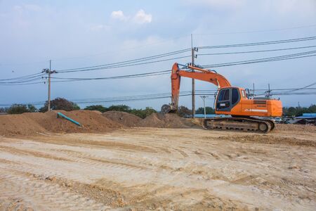 large diesel mechanical excavator digging earth machine at excavation working in  construction siteの写真素材