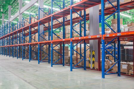 The empty rows of shelves with boxes in warehouse.の写真素材