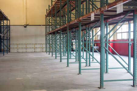 The empty rows of shelves with boxes in warehouse.の写真素材