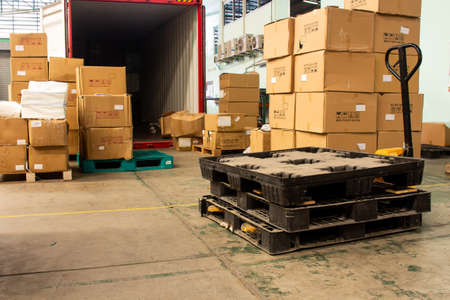 The cartons with loading out of containerの写真素材