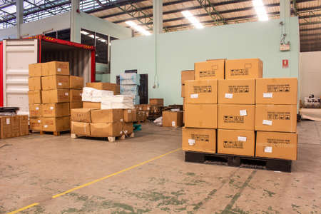 The cartons with loading out of containerの写真素材