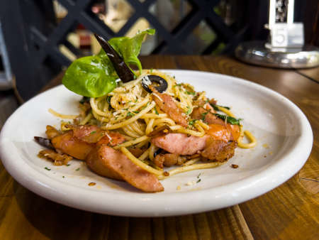 The Stir-Fried Spaghetti With Dried Chili And Crispy Bacon and sausageの写真素材