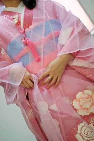 a pink traditional Japanese lady's formal outfit (kimono) with flower patternsの写真素材