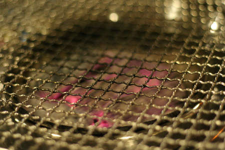 a Korean style BBQ with metal grillsの写真素材