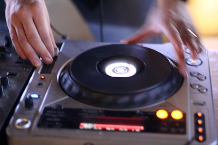 a DJ at the club mixing on the decksの写真素材