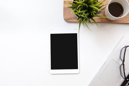Desk table top overhead space design layout place right tablet isolated for insert in screen and plant with coffee cup on wood down have glasses laptopの写真素材