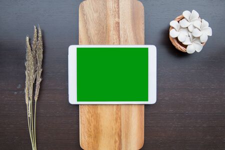 Desk table top overhead work space place object layout center have tablet green screen for insert on woodの写真素材