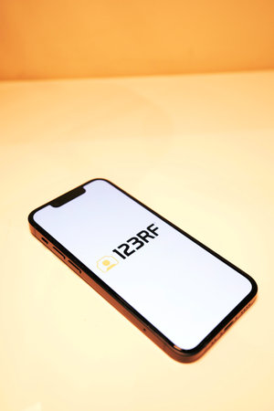 October 3, 2022: 123RF logo on smartphone screen. Smartphone on the table.のeditorial素材