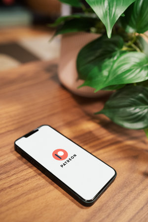 October 6, 2022: Patreon logo on smartphone screen. Smartphone on tableのeditorial素材