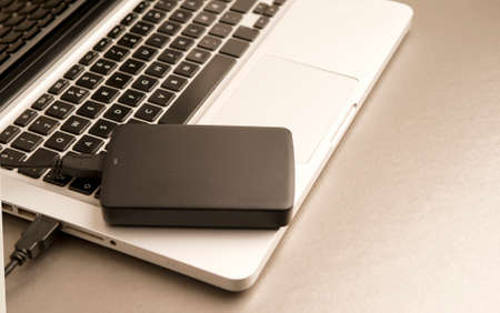 black external hard drive, laptop, on gilt metal table.concept office.