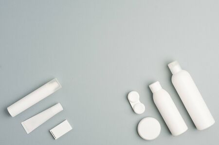 plane collection of various beauty hygiene containers on soft gray background. Space to fill.top view.の写真素材
