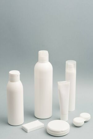 ollection of various beauty hygiene containers on soft gray background.の写真素材