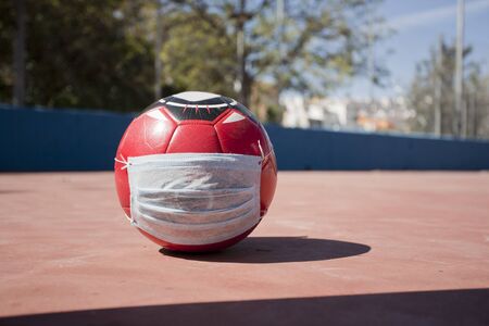 2019-nCoV, soccer ball wearing a surgical mask. Surgical team to prevent coronavirus.football schoolの写真素材