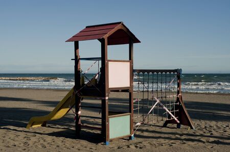 playground closed by covip-19, on sandy beach, blue sky in the backgroundの写真素材