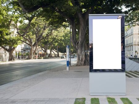 billboard in center city with trees and buildings in the backgroundの写真素材