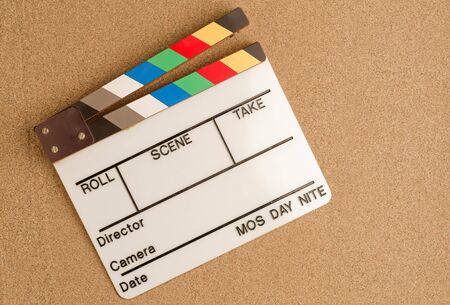 vacation, travel and summer vacation concept: movie clapperboard on the beach sandの写真素材