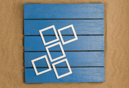 blue wood and sea sand with frames for photo mockups. Top viewの写真素材