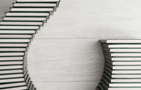 stacked books, make elegant shape, black and white, wooden background, top viewの写真素材