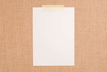 Texture or background of brown sackcloth and white notepad sheet with empty space.の写真素材