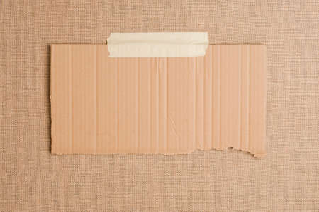 Texture or background of brown sackcloth and piece of cardboard with empty space.の写真素材