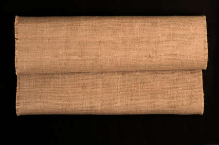 Natural linen texture rolled up, black background .top viewの写真素材