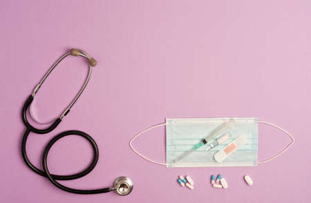 Covid-19 coronavirus concept. Accessories medicine, prevention and vaccination coronavirus, lilac background, text space, top view.の写真素材