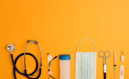 Covid-19 Coronavirus concept. accessories medicine, prevention coronavirus, orange background with copy space. top viewの写真素材