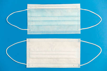 covid-19 concept, protection and hygiene, masks, blue background. top viewの写真素材