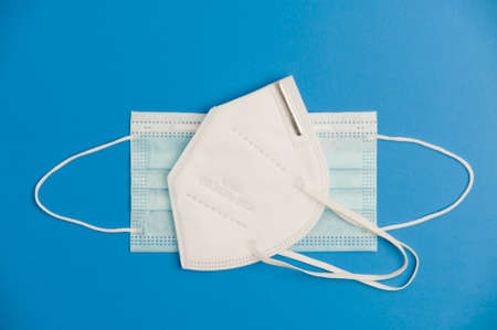 Covid-19 concept, protection and hygiene, mask 2 types, blue background. Top viewの写真素材