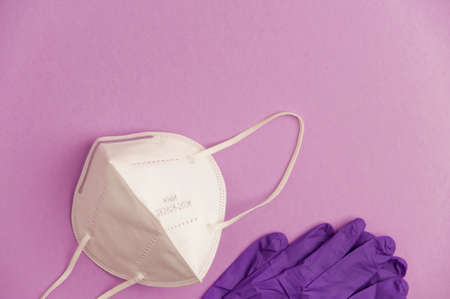 covid-19 concept, protection and hygiene, mask with gloves, purple background