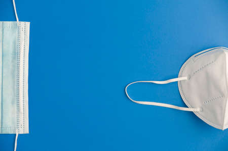 Covid-19 concept, protection and hygiene, partial view 2 types of mask blue background. Top viewの写真素材