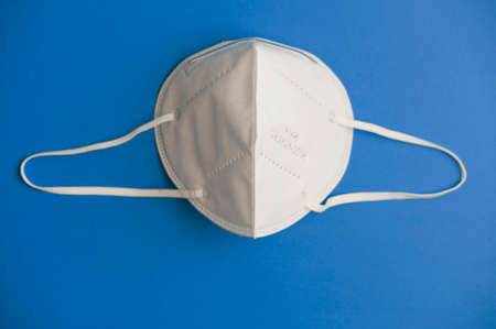 covid-19 concept, nk95 virus protection mask with blue background, space for text. top viewの写真素材