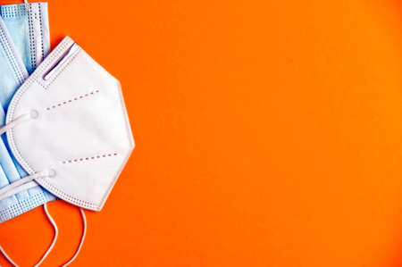 covid-19 concept, masks different types, protection covid-19 virus, orange background, space for text. top viewの写真素材