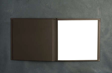 Rectangular open black book with white right side (photo album) on gray background. top viewの写真素材