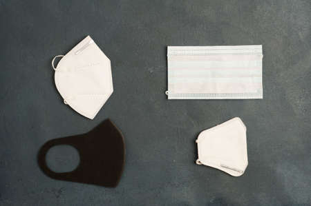covid concept, different types of masks, on gray background. top viewの写真素材