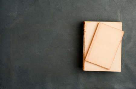 old books with smooth cover on top big book, on gray background. top viewの写真素材